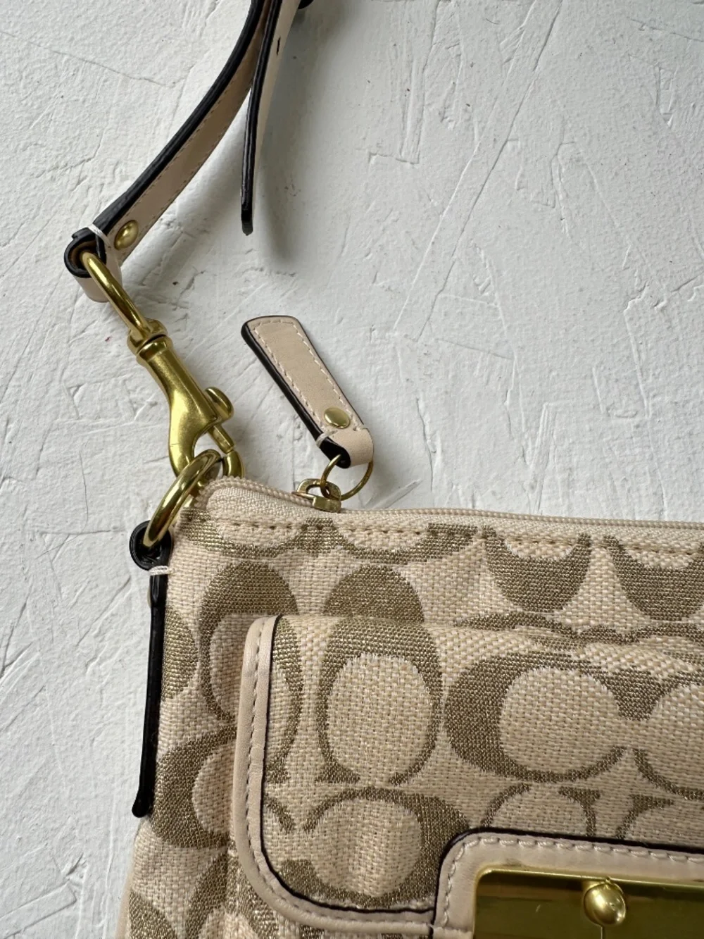 Coach Kristin Signature Crossbody Swing Bag in a metallic gold and beige fabric